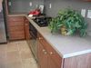 Granite Densified Solid Surface Kitchen Countertop. Notice how backsplash goes up to the bttm of top cabinets